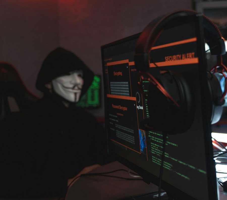 Person in Black Hoodie Hacking a Computer System
