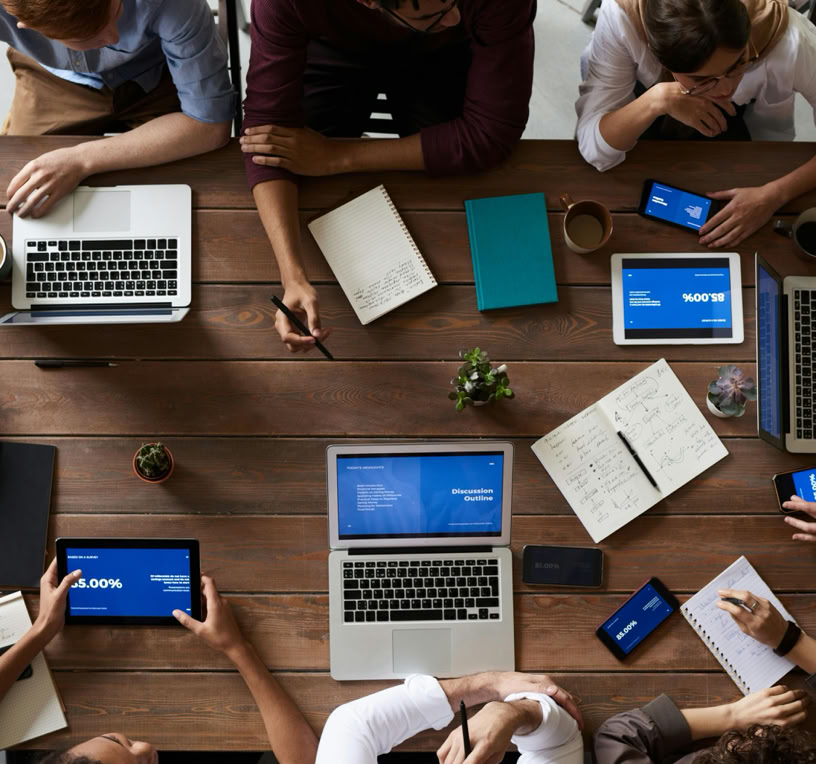Top View Photo Of People Near Wooden Table